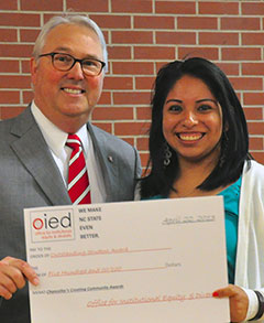 Guadalupe Arce-Jimenez receiving award from Chancellor Woodson
