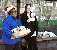 Staff Women's Network - members wait at Wolfline bus stop to give mugs to drivers