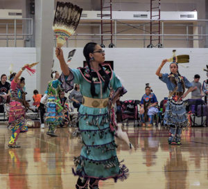 Native woman dancing in tribal dress
