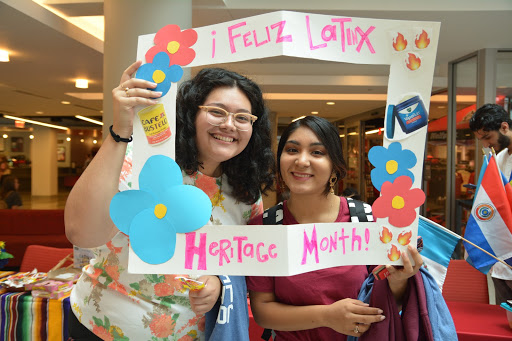 Students with Latinx Heritage Month sign